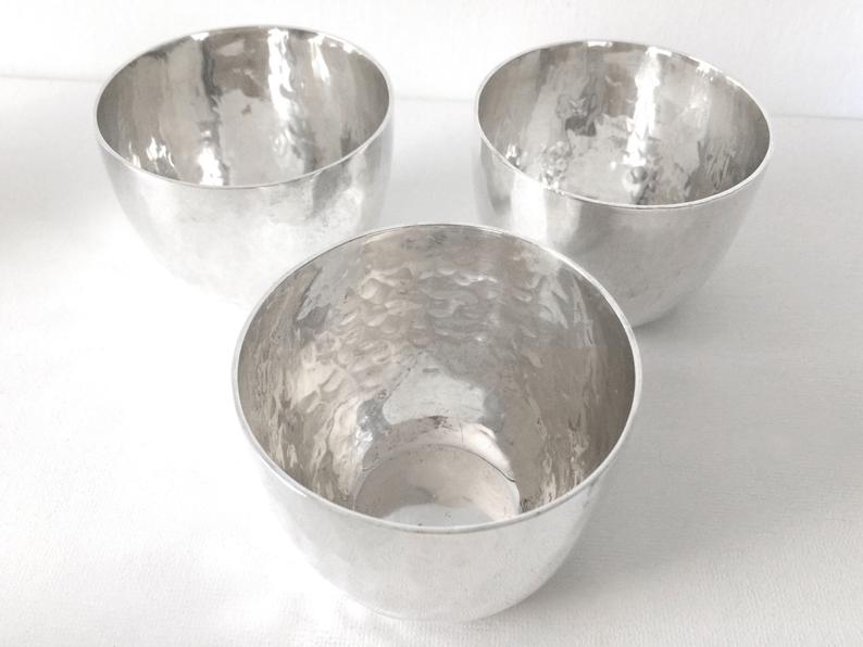 Handcrafted 999 pure silver fully hammered water glass with a 200 ml capacity, featuring a textured traditional design and polished finish.