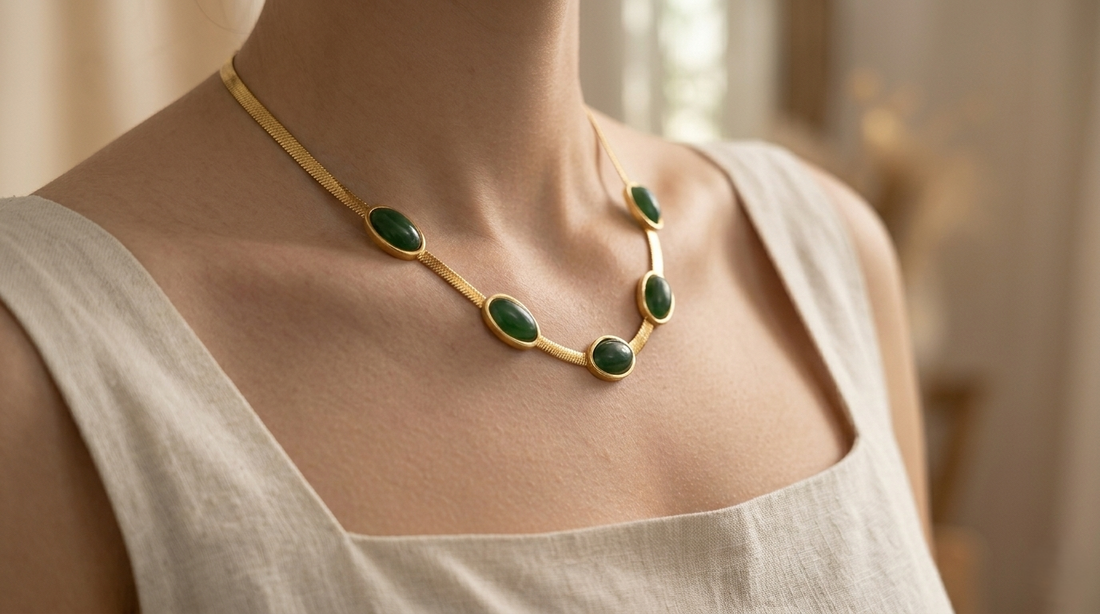 Elegant emerald green gold statement necklace with oval gemstone accents worn by a woman, chic minimalist choker jewelry for women with luxury-inspired design.