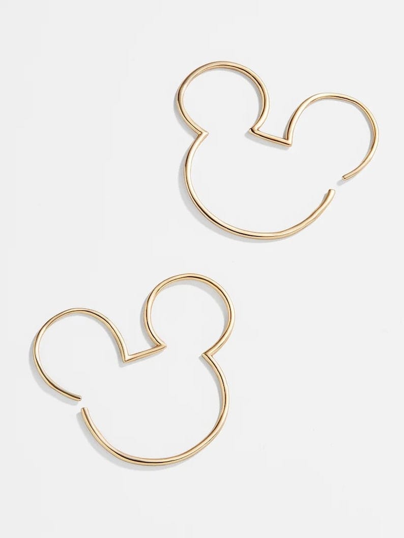 A pair of 925 silver hoop earrings featuring a Mickey Mouse silhouette in gold color.