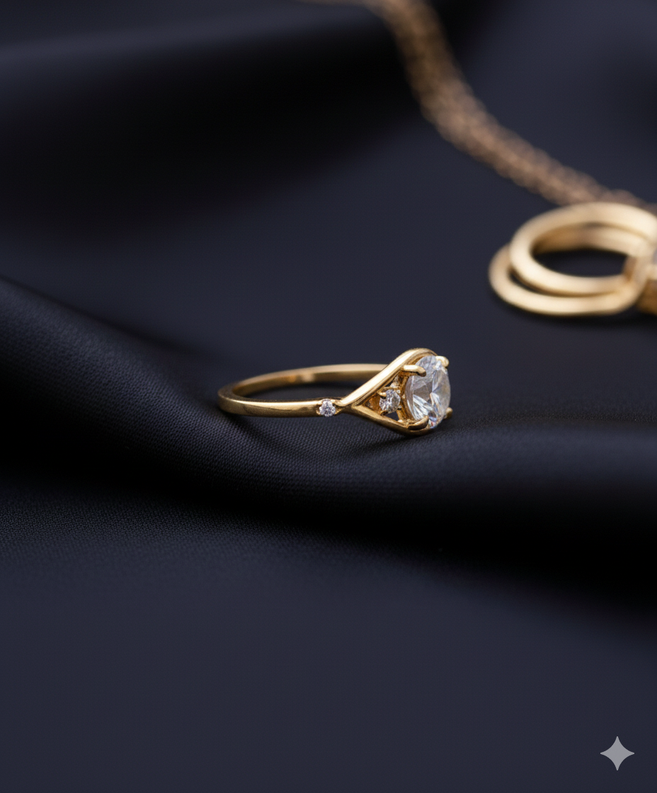 Oval cut diamond engagement ring set in yellow gold, featuring a central oval diamond with two smaller side stones on a sleek, modern band.