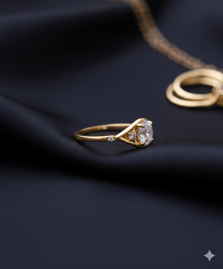 Oval cut diamond engagement ring set in yellow gold, featuring a central oval diamond with two smaller side stones on a sleek, modern band.